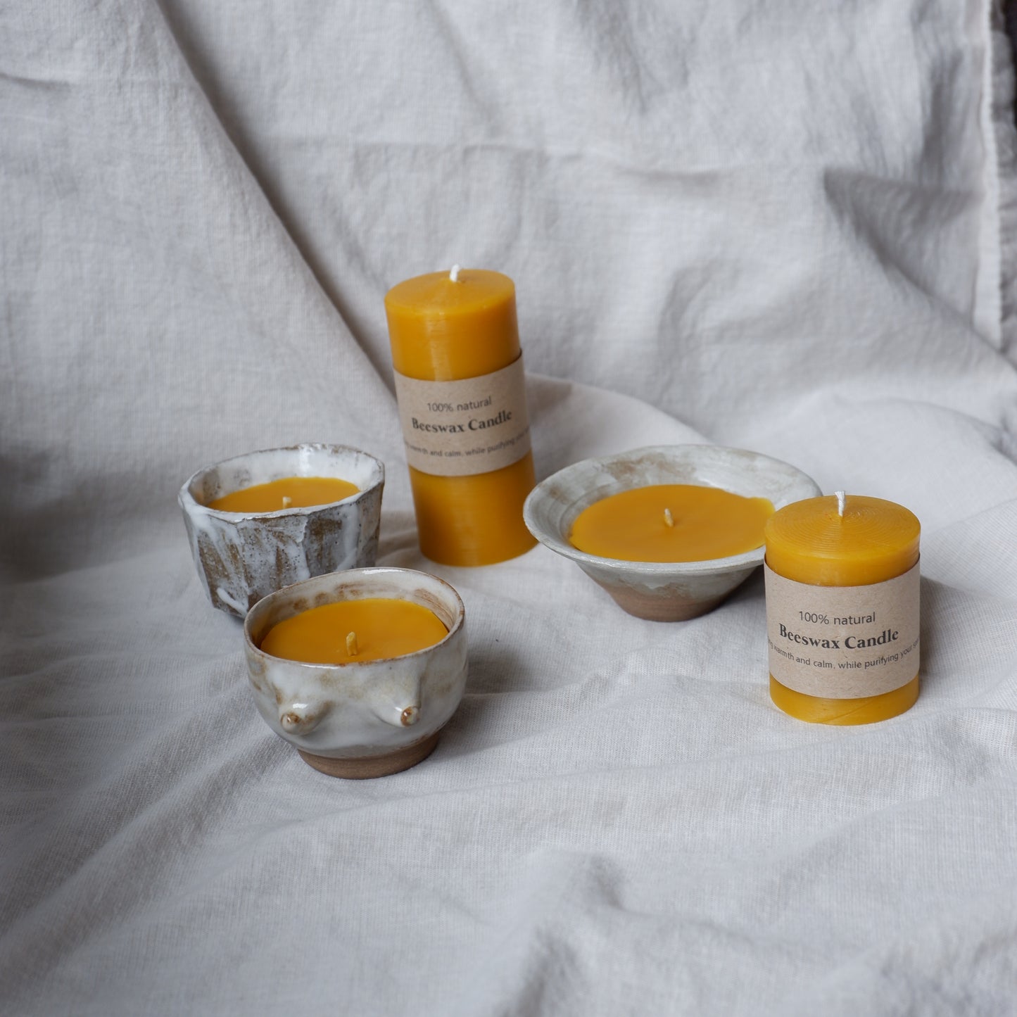 Beeswax candle in handmade ceramics