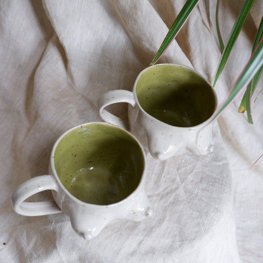 Beige mugs with green inside