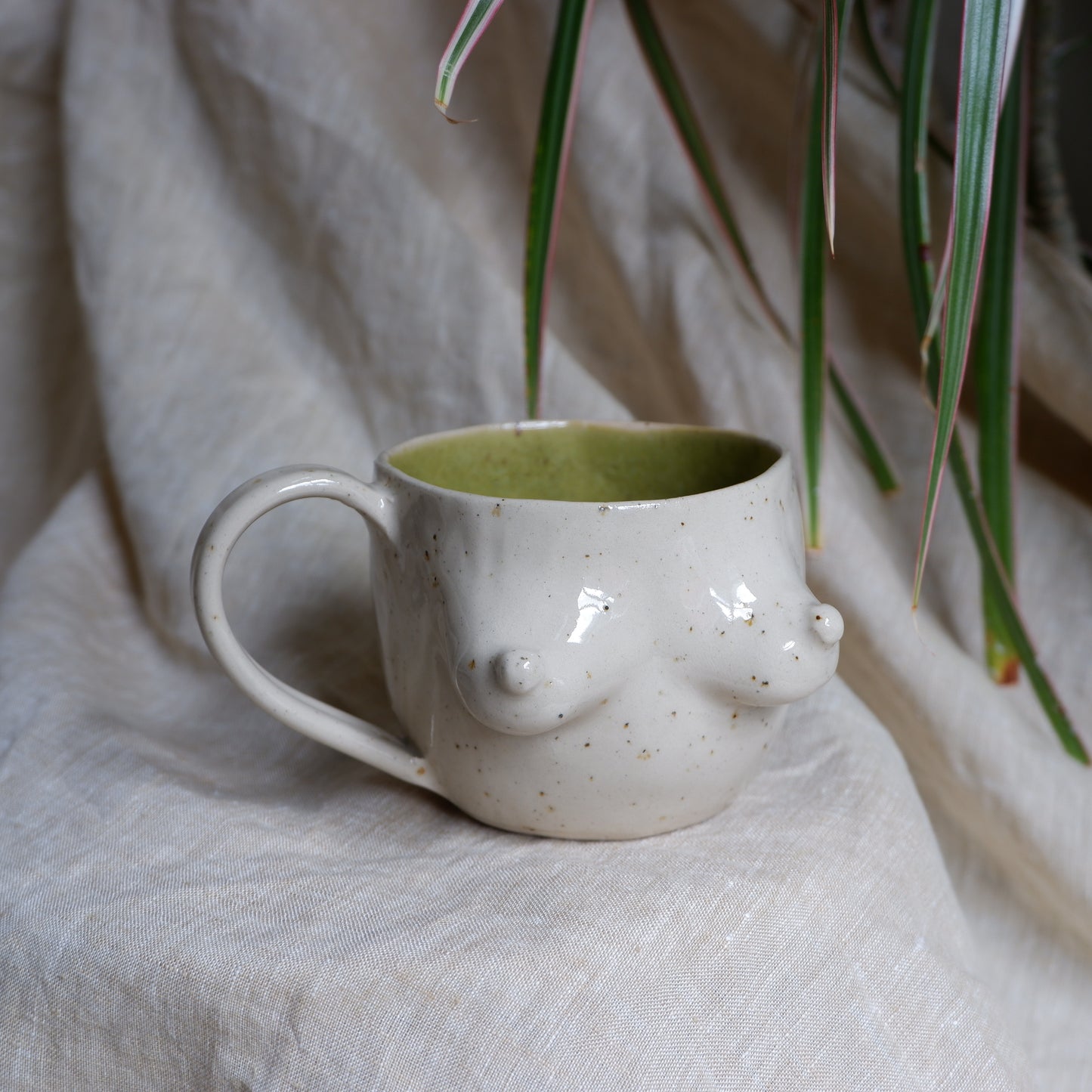 Beige mugs with green inside