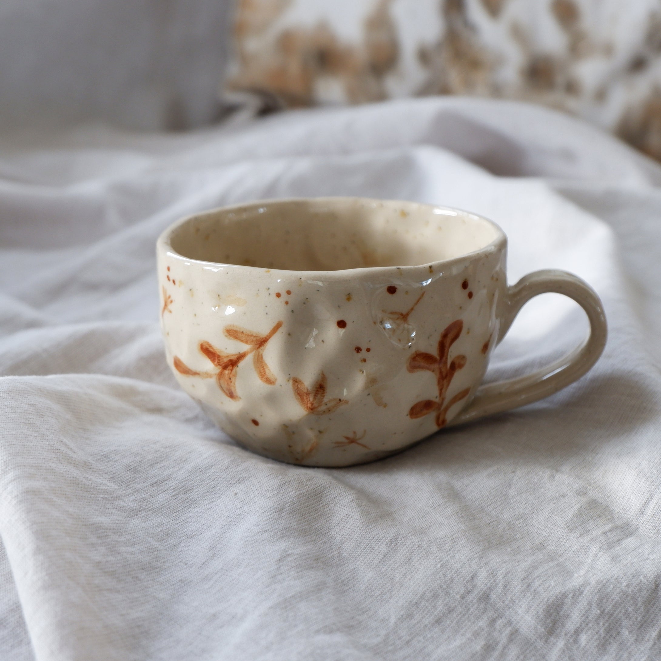 Speckled beige mug with hand-painted brown details