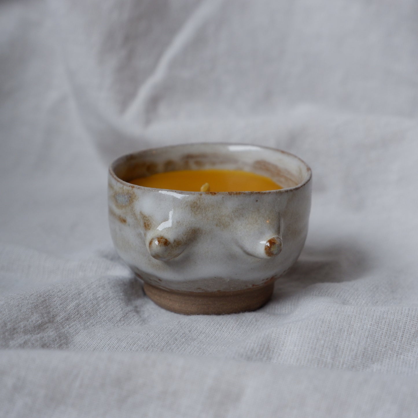 Beeswax candle in handmade ceramics