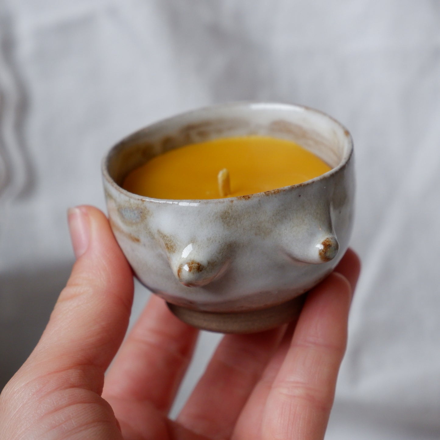 Beeswax candle in handmade ceramics