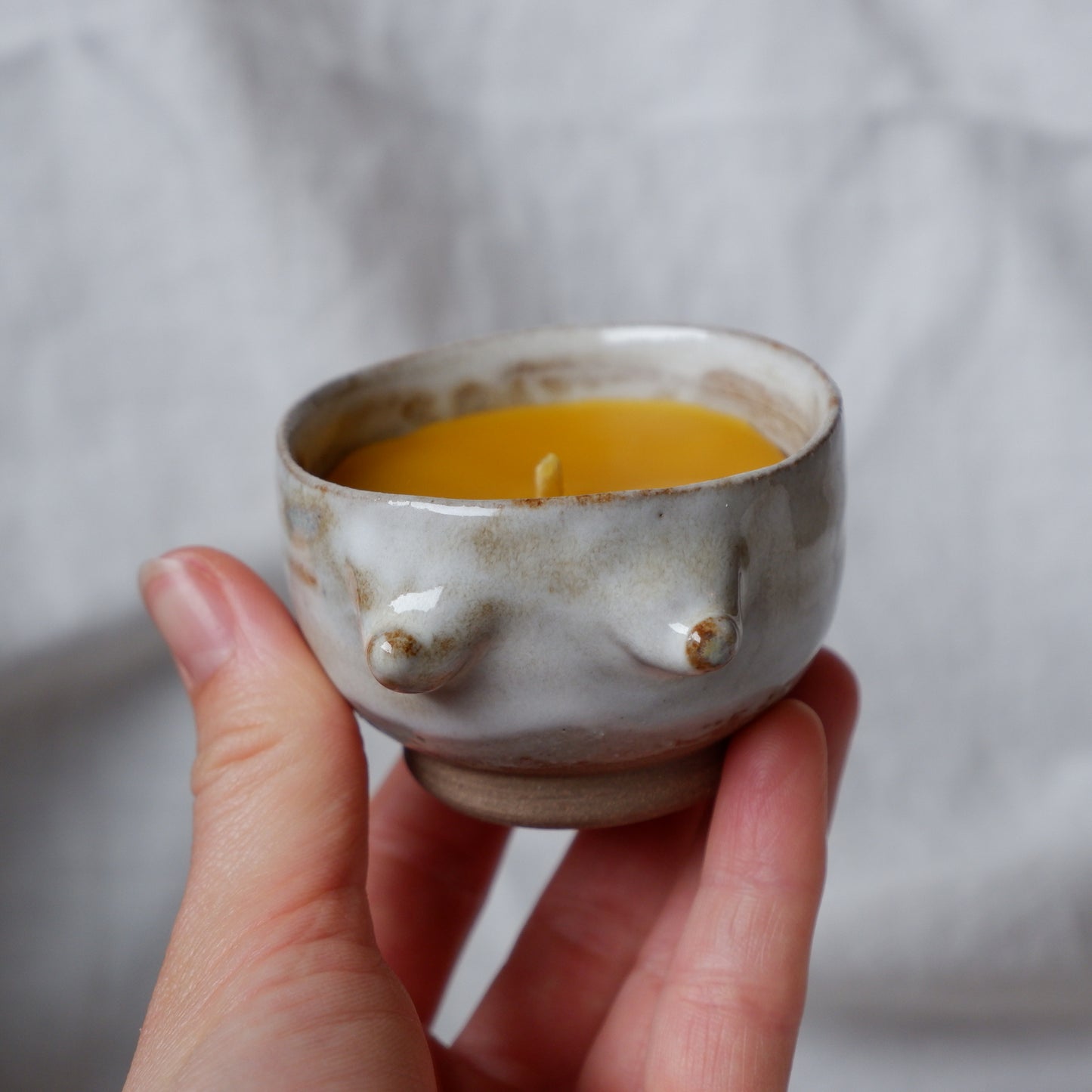 Beeswax candle in handmade ceramics