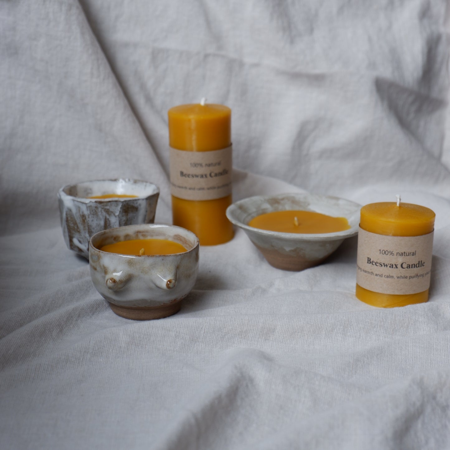 Beeswax candle in handmade ceramics
