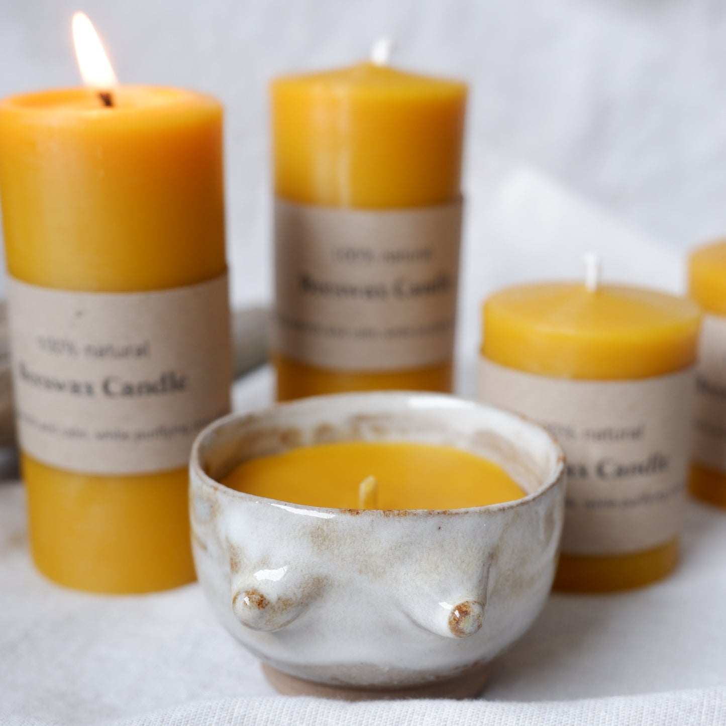 Beeswax candle in handmade ceramics