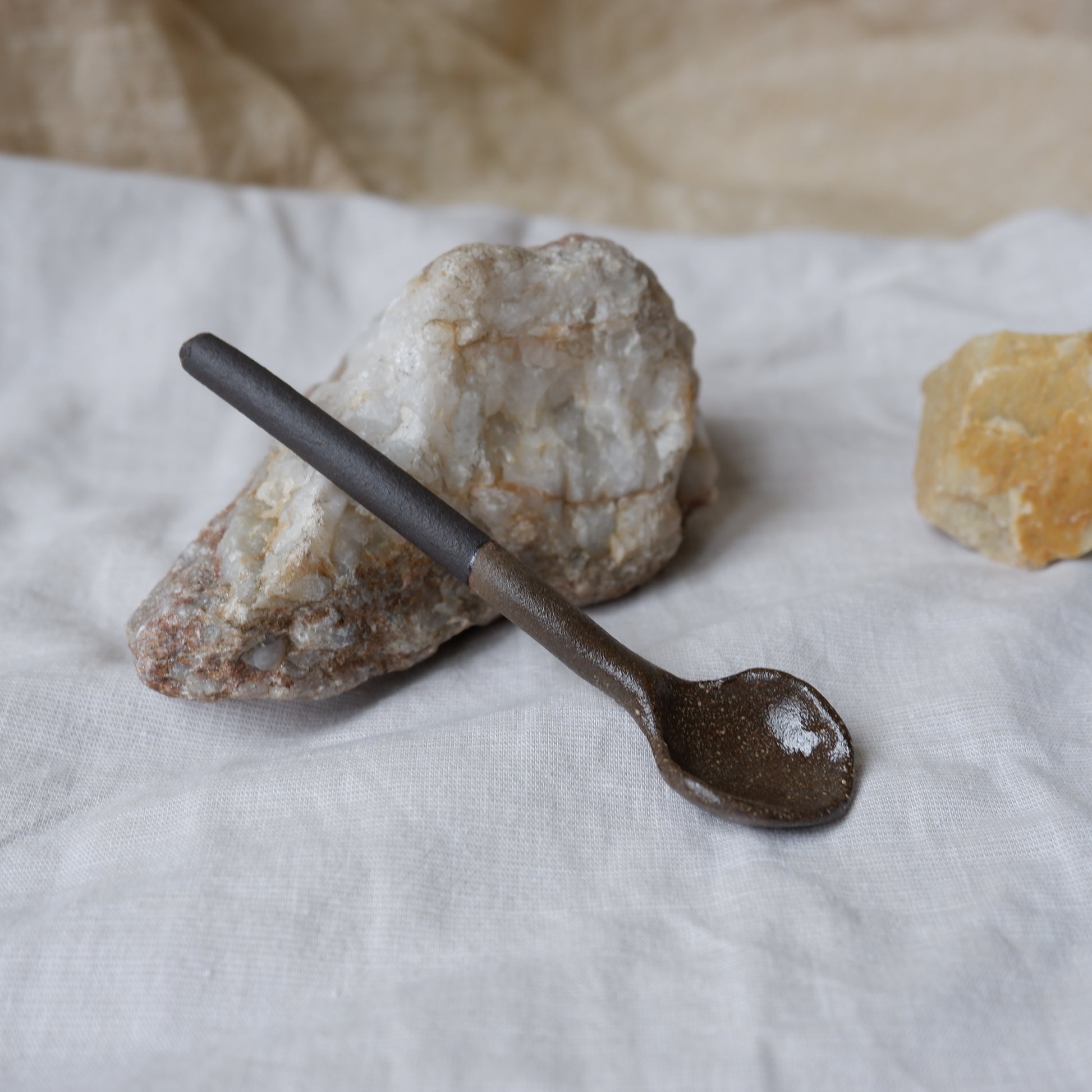 Decorative spoon on a stone surface with a neutral background