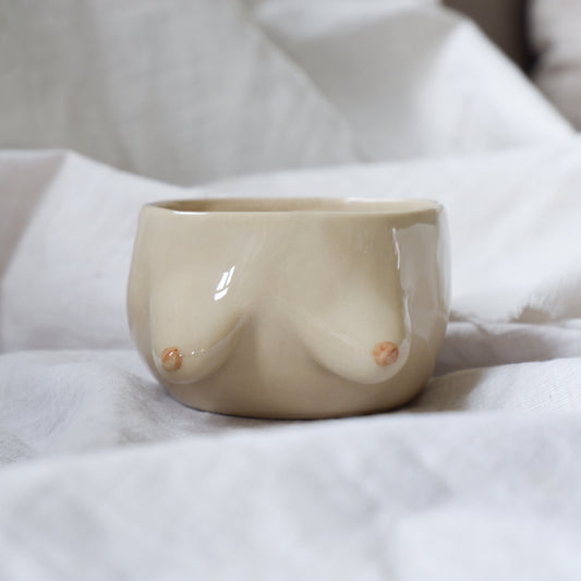 Beige mug with light brown details, without a handle