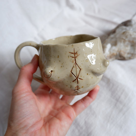 Carved tattoo mug with the piercing // symbolizes prosperity, transformation, and purposeful movement