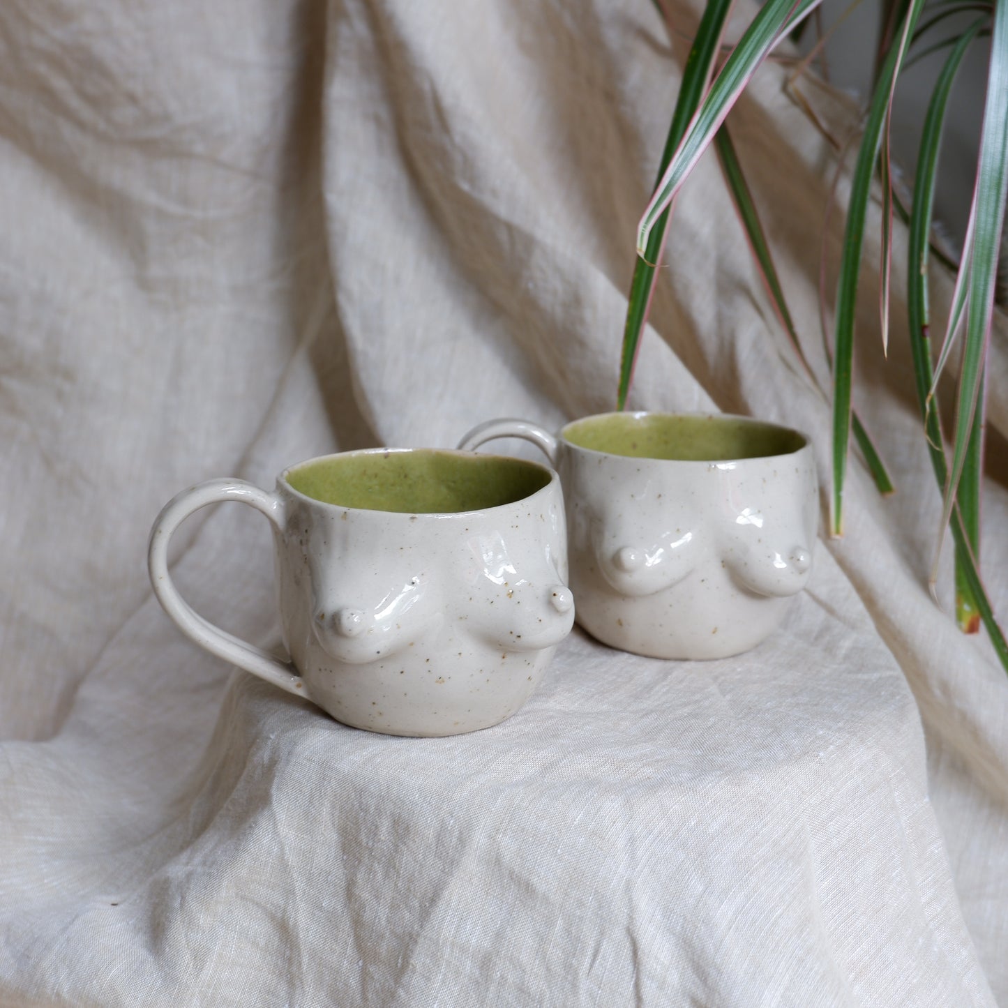 Beige mugs with green inside