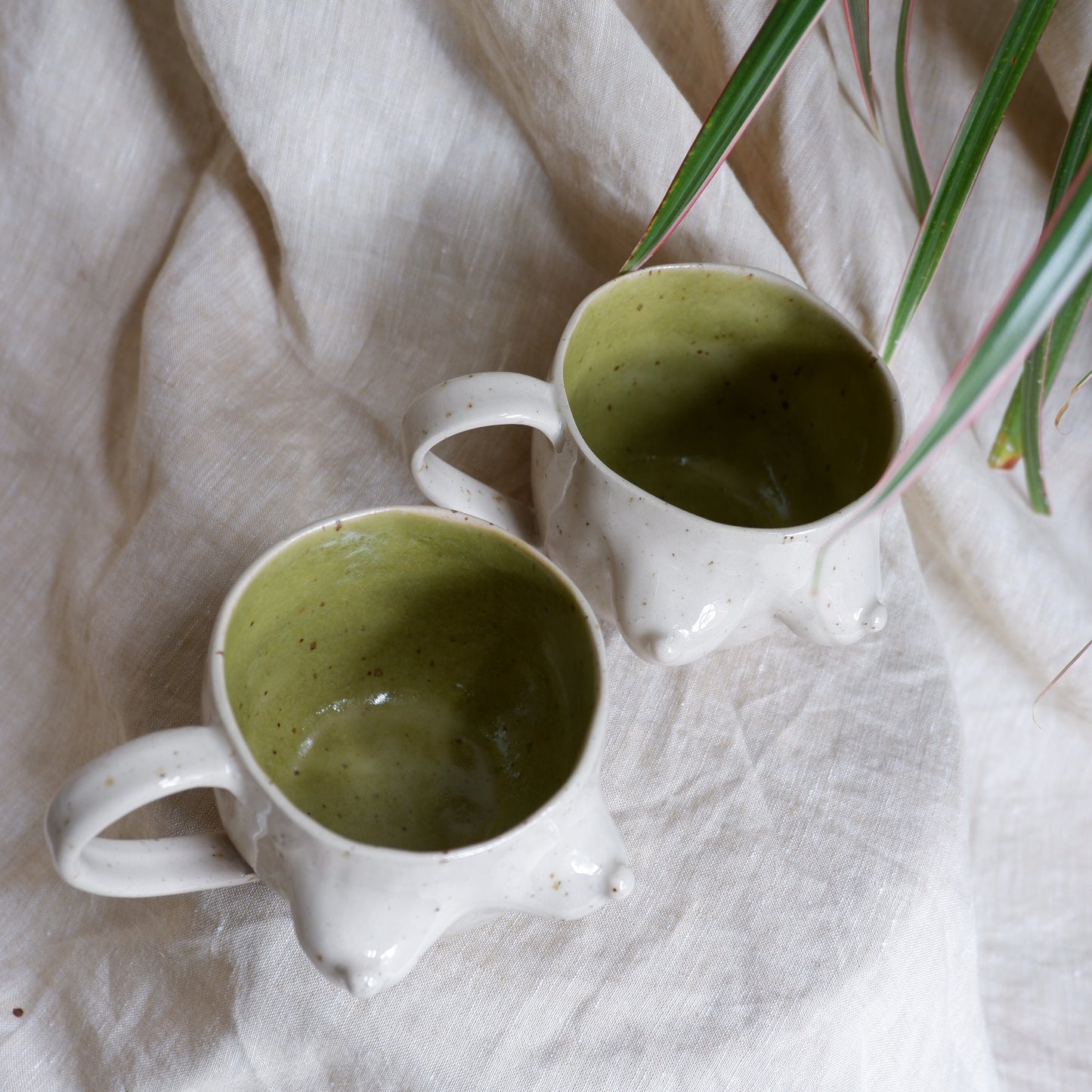 Beige mugs with green inside