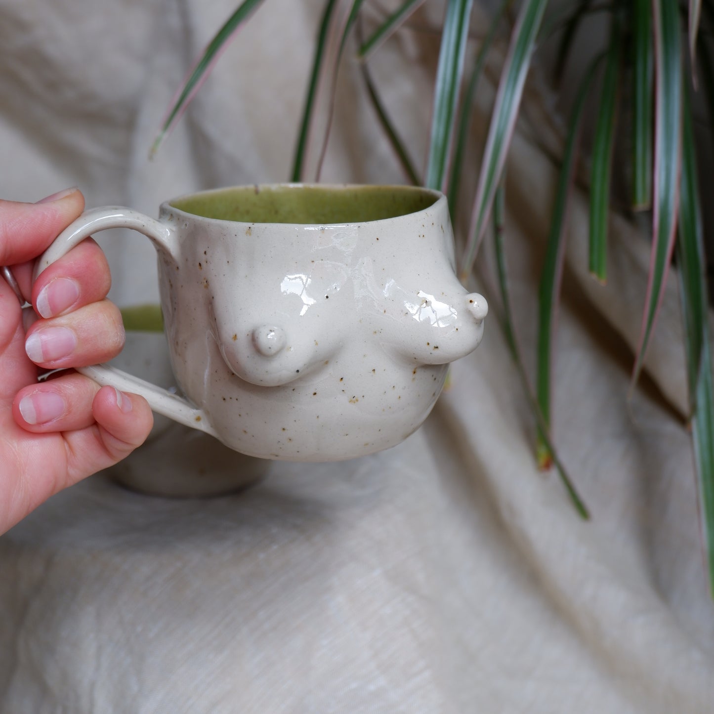 Beige mugs with green inside