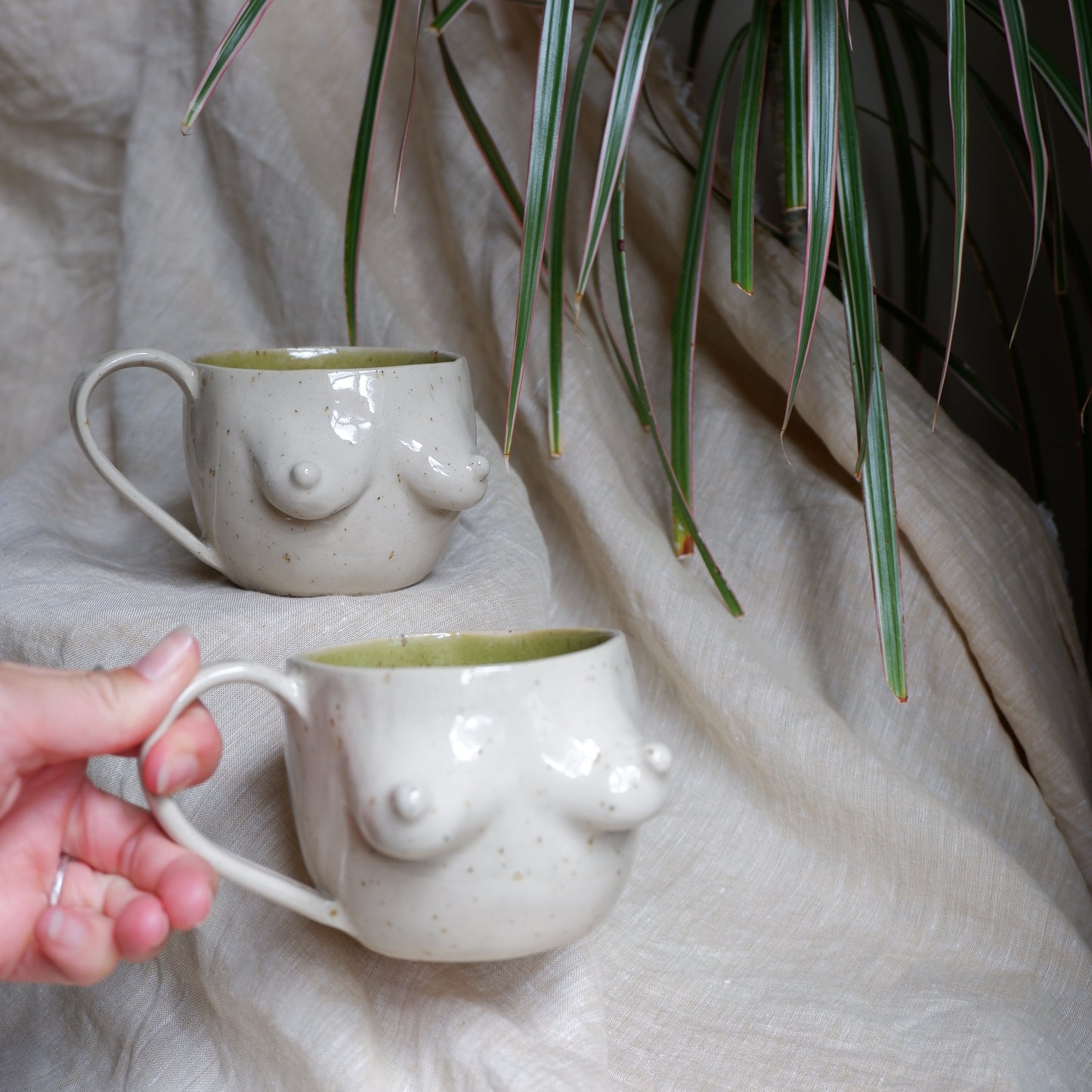 Beige mugs with green inside