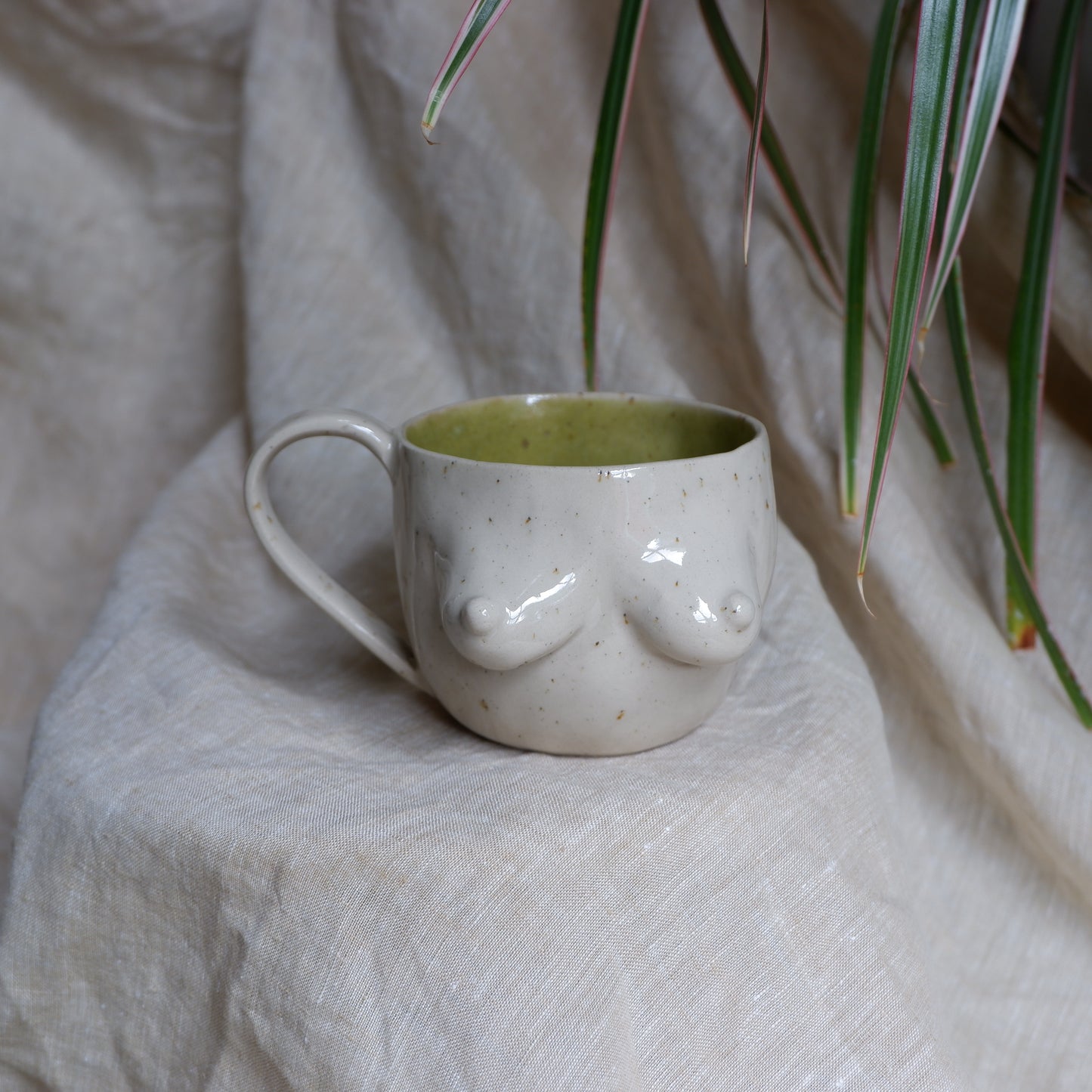 Beige mugs with green inside