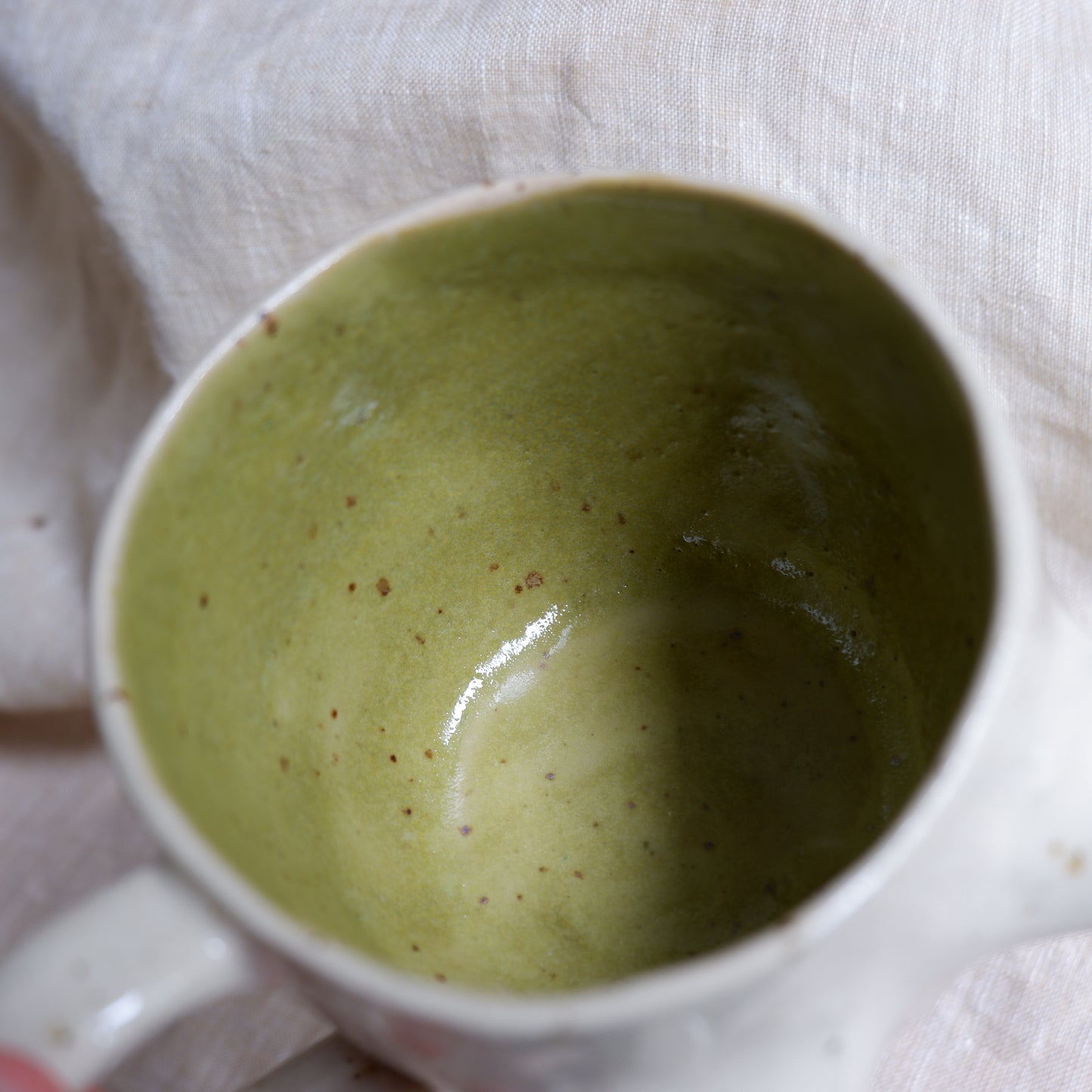 Beige mugs with green inside