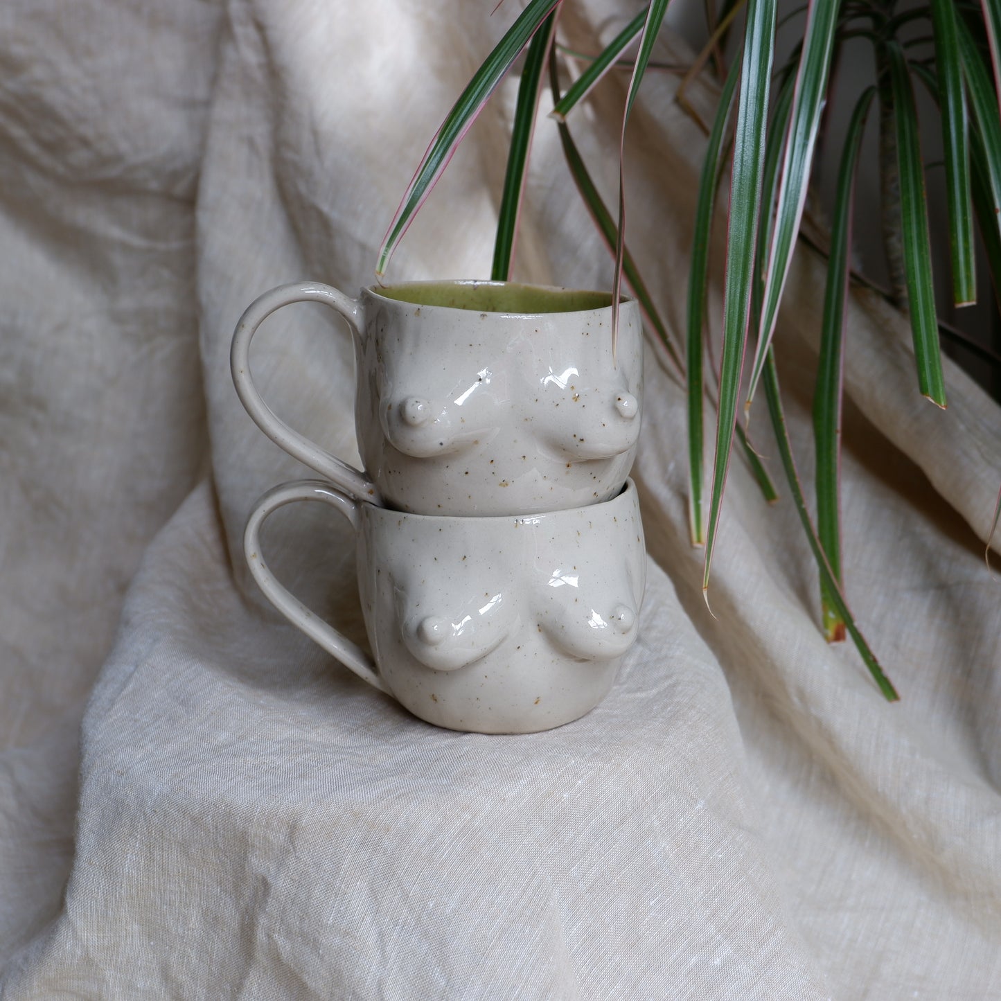 Beige mugs with green inside