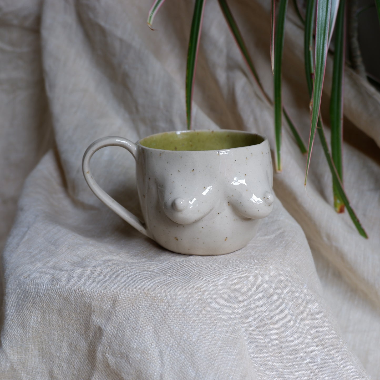 Beige mugs with green inside