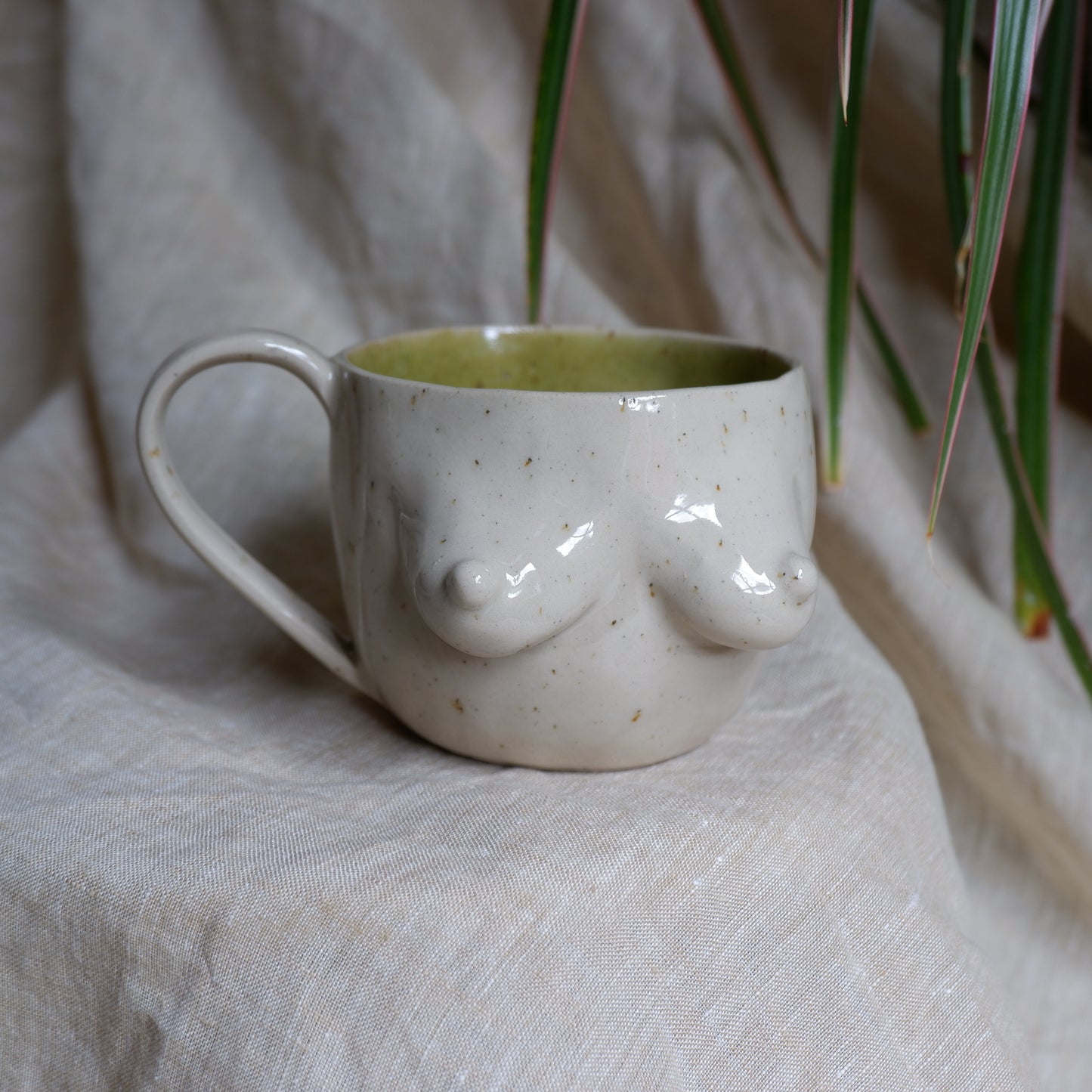 Beige mugs with green inside