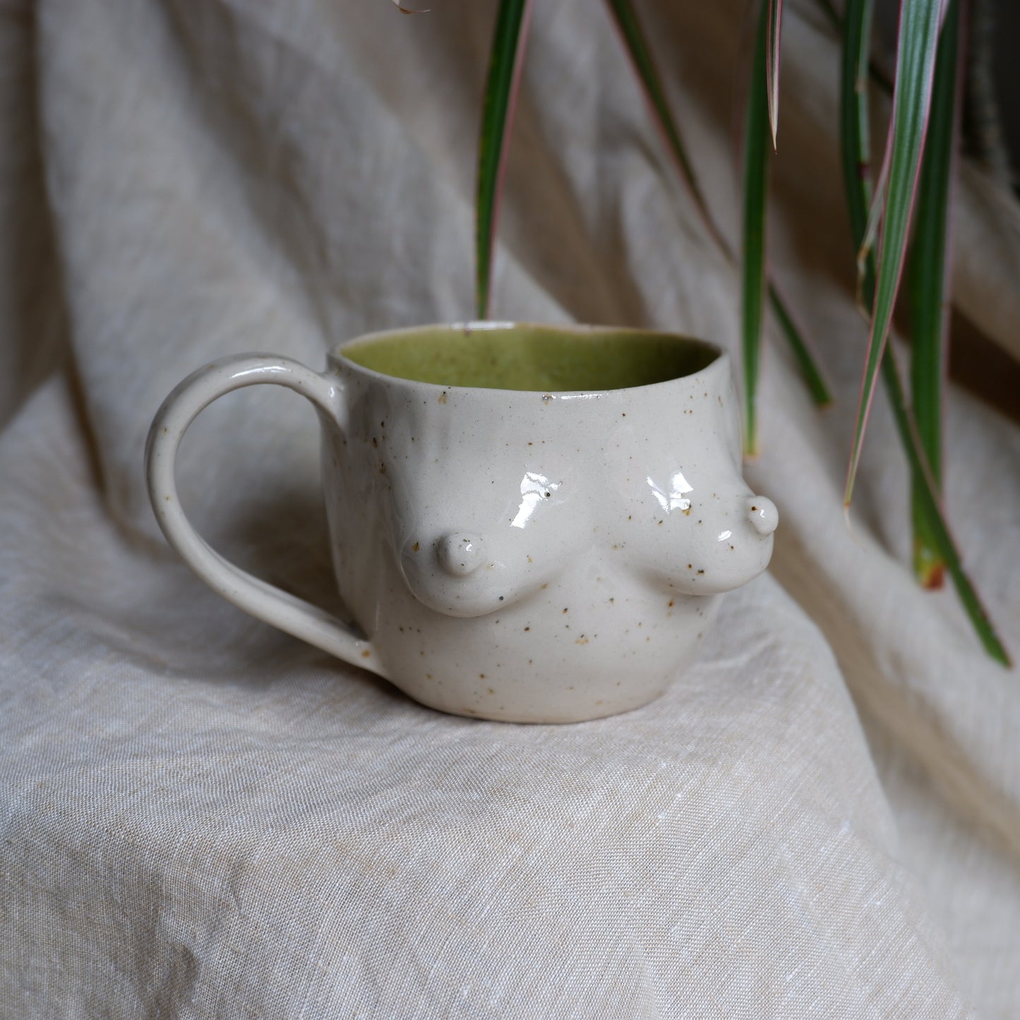 Beige mugs with green inside